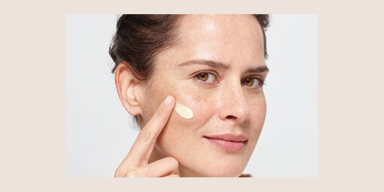 A lady applying pressed cream